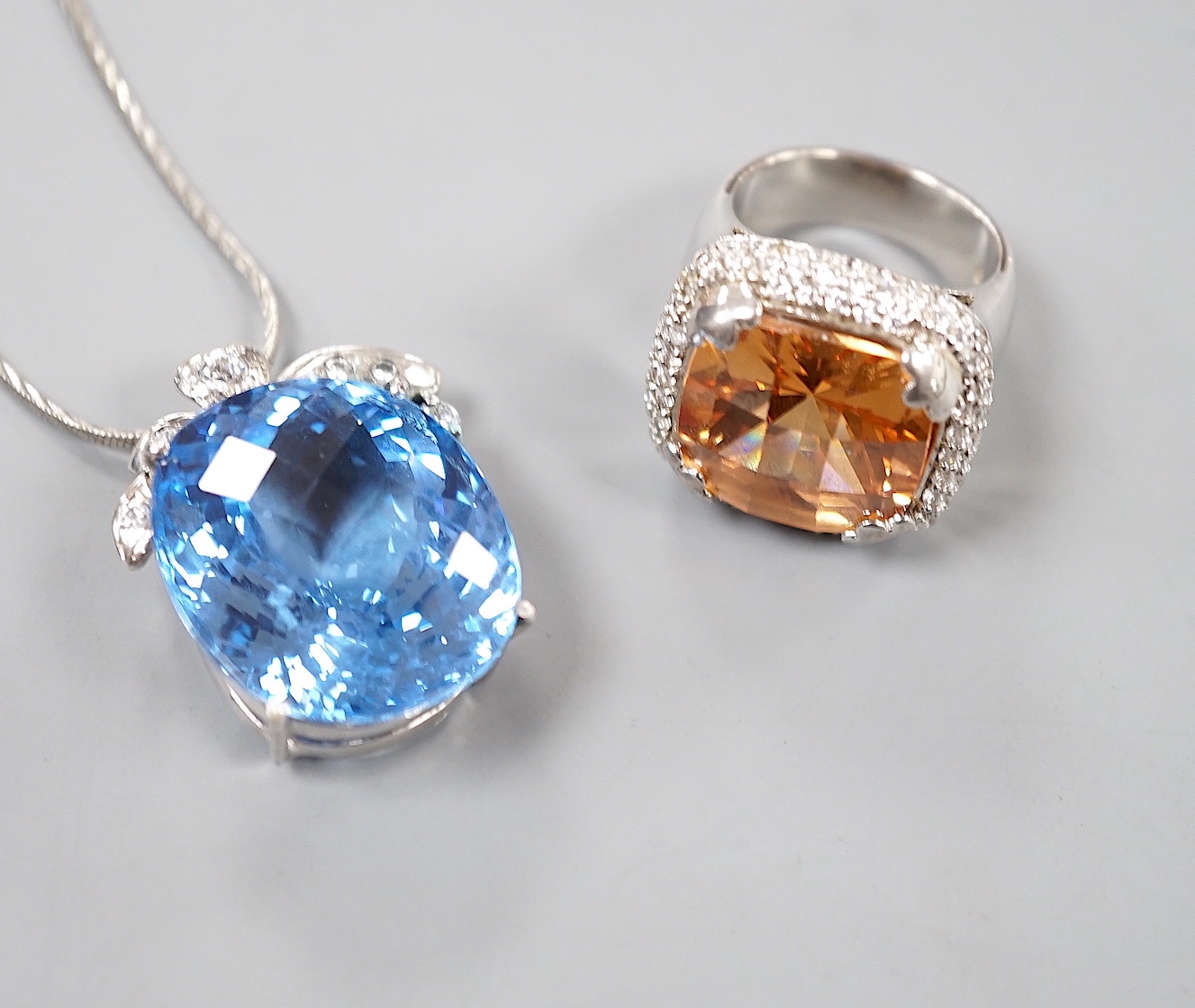A modern 925 and paste set dress ring and a blue and white paste cluster set pendant on chain.